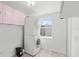 Efficient laundry room equipped with a stacked washer and dryer, plus storage cabinets at 8608 N 20Th St, Tampa, FL 33604