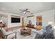Cozy living room features hardwood floors, a ceiling fan, and access to the adjacent kitchen at 8608 N 20Th St, Tampa, FL 33604