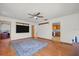 Spacious living room with hardwood flooring, a ceiling fan, and convenient access to the kitchen at 8608 N 20Th St, Tampa, FL 33604
