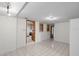 Bright living room featuring tile floors and an open doorway to the kitchen at 8608 N 20Th St, Tampa, FL 33604