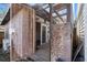 View of the shed entrance with a metal gate and wooden deck at 8608 N 20Th St, Tampa, FL 33604