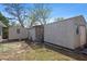 View of backyard sheds in a grassy yard, offering extra storage solutions at 8608 N 20Th St, Tampa, FL 33604
