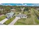 Aerial view of home showing the driveway, lush landscaping and surrounding neighborhood at 7280 Meroni Blvd, North Port, FL 34291