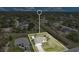 A property view showcases a landscaped yard, lengthy driveway, and a well-situated home within a tree-lined neighborhood at 7280 Meroni Blvd, North Port, FL 34291