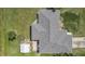 This is an aerial shot showing roof, green lawn, and the shed in the backyard at 7280 Meroni Blvd, North Port, FL 34291