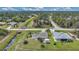 Aerial view of a home with a long driveway and lush landscaping at 7280 Meroni Blvd, North Port, FL 34291