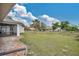 This is a landscaped backyard with a covered porch, shed and established trees at 7280 Meroni Blvd, North Port, FL 34291