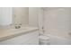 Clean bathroom features a shower-tub combo, white vanity, and neutral finishes at 7280 Meroni Blvd, North Port, FL 34291