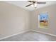 Bedroom features a large window providing natural light and views of the backyard at 7280 Meroni Blvd, North Port, FL 34291
