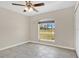 Bright bedroom with large window, closet, and neutral paint, ready for your personal touch at 7280 Meroni Blvd, North Port, FL 34291