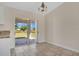 Bright dining area featuring tile flooring and sliding glass doors leading to a patio at 7280 Meroni Blvd, North Port, FL 34291