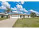 Charming single-story home featuring a two-car garage and well-maintained lawn at 7280 Meroni Blvd, North Port, FL 34291