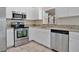 Bright kitchen featuring white cabinets, stainless steel appliances, and granite countertops at 7280 Meroni Blvd, North Port, FL 34291