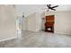 Spacious living room featuring tile flooring, fireplace, and a ceiling fan at 7280 Meroni Blvd, North Port, FL 34291