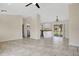 Open-concept living area with tile floors, ceiling fan, and sliding doors to the outside at 7280 Meroni Blvd, North Port, FL 34291