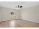 Main bedroom with wood flooring and large window that lets in lots of natural light at 7280 Meroni Blvd, North Port, FL 34291