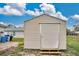 This shows a tan shed with a metal door, with steps leading to the door at 7280 Meroni Blvd, North Port, FL 34291