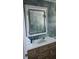 Bathroom featuring updated vanity with storage and a modern backsplash at 1825 Alberta Dr, Clearwater, FL 33756