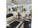 Comfortable bedroom featuring a ceiling fan, striking black and white accents, and a stylish round accent table at 1825 Alberta Dr, Clearwater, FL 33756