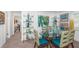Dining room featuring a glass table, decorated shelving, and modern flooring at 1825 Alberta Dr, Clearwater, FL 33756