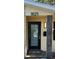 Close-up of the front door with contemporary design and address plaque at 1825 Alberta Dr, Clearwater, FL 33756