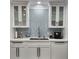 Modern kitchen with custom cabinets, mosaic backsplash and stainless steel appliances at 1825 Alberta Dr, Clearwater, FL 33756
