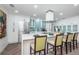 Bright kitchen boasts white cabinets, stainless steel appliances, and a spacious island with bar seating at 1825 Alberta Dr, Clearwater, FL 33756