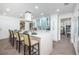 Bright kitchen boasts white cabinets, stainless steel appliances, and a spacious island with bar seating at 1825 Alberta Dr, Clearwater, FL 33756
