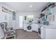 Well-organized laundry room with modern washer, dryer, cabinets, and charming decor at 1825 Alberta Dr, Clearwater, FL 33756