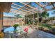 Covered patio featuring a glass table and chairs with a fenced-in backyard at 1825 Alberta Dr, Clearwater, FL 33756