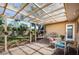 Covered patio featuring a glass table, chairs, and a fenced-in backyard at 1825 Alberta Dr, Clearwater, FL 33756
