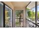 Enclosed balcony area with a view of lush landscaping and tropical trees at 5729 Baywater Dr # 5729, Tampa, FL 33615