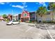 Attractive condo complex with vibrant exterior, lush landscaping, visitor parking, and clear blue skies at 5729 Baywater Dr # 5729, Tampa, FL 33615