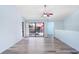 Bright living room with modern flooring, ceiling fan, and sliding door to outdoor space at 5729 Baywater Dr # 5729, Tampa, FL 33615