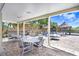 Outdoor seating area with multiple tables for dining and socializing, under a covered patio at 5729 Baywater Dr # 5729, Tampa, FL 33615