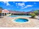 Community pool with hot tub, lounge seating, and manicured landscaping at 5729 Baywater Dr # 5729, Tampa, FL 33615