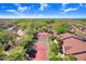 Aerial view of well-maintained tennis courts surrounded by lush greenery and neighborhood scenery at 5729 Baywater Dr # 5729, Tampa, FL 33615