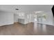 Open living room boasting sleek floors, recessed lighting, and sliding glass doors to a screened lanai at 1136 Flamingo Rd, Venice, FL 34293
