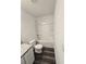 Clean bathroom featuring a toilet, bathtub with shower, and modern wood-look flooring at 11856 Throttle Pl, Gibsonton, FL 33534