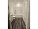 Well-lit bathroom with a tub, toilet, and vanity at 11856 Throttle Pl, Gibsonton, FL 33534