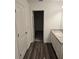 Well-lit bathroom with a vanity, closet, and wood-look floors at 11856 Throttle Pl, Gibsonton, FL 33534