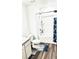 This bathroom offers wood flooring, marble counters and shower/bath combo at 11856 Throttle Pl, Gibsonton, FL 33534