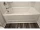 Close-up of a clean white bathtub with chrome fixtures, showcasing modern design and functionality at 11856 Throttle Pl, Gibsonton, FL 33534