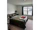 Cozy bedroom with a large window and plush carpeting for ultimate comfort at 11856 Throttle Pl, Gibsonton, FL 33534