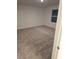 Empty bedroom with gray carpet and a window at 11856 Throttle Pl, Gibsonton, FL 33534