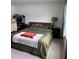 Bedroom featuring a bed with wooden headboard, nightstand, and a workstation at 11856 Throttle Pl, Gibsonton, FL 33534