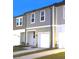 Exterior view of a two-story townhome featuring a gray facade and a one-car garage at 11856 Throttle Pl, Gibsonton, FL 33534