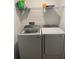 Laundry room featuring a newer Samsung washer and dryer set with wire rack storage at 11856 Throttle Pl, Gibsonton, FL 33534