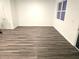 Bright living room with hard wood floors, white walls, and a large window for ample natural light at 11856 Throttle Pl, Gibsonton, FL 33534