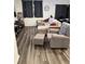 Comfortable living room boasts stylish furniture with wood-look flooring at 11856 Throttle Pl, Gibsonton, FL 33534